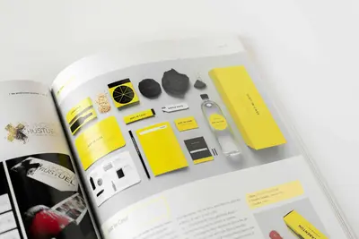 A magazine with brand identity designs on the pages.